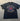 Black t-shirt with 'Melbourne Bitter' logo on a gray surface